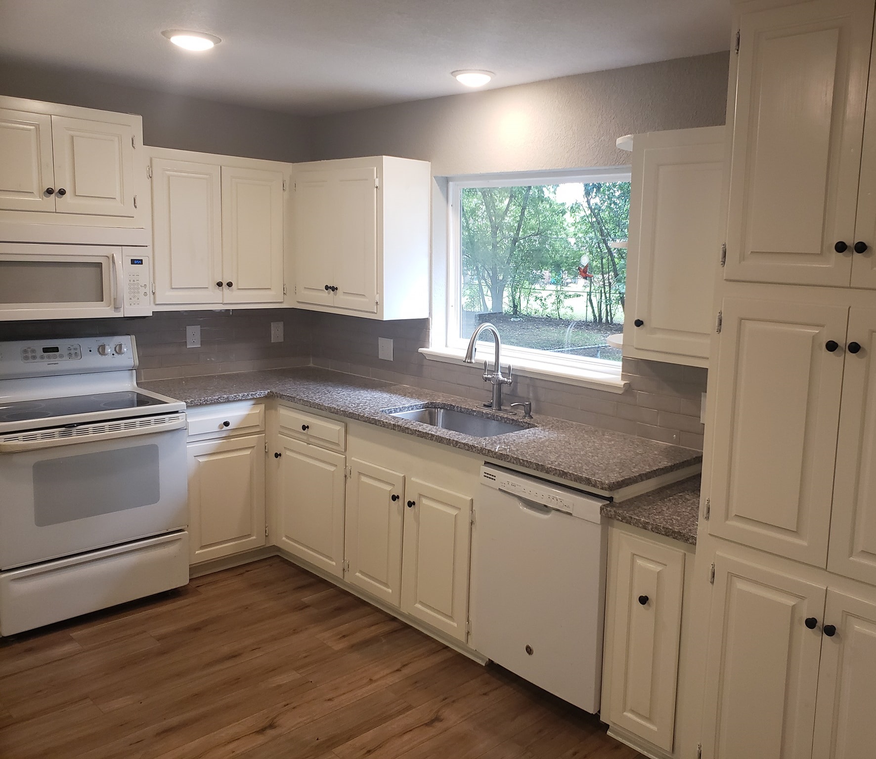 Freshly painted kitchen with vibrant colors, showcasing handyman's skill and precision