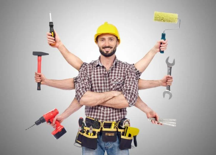 Handyman with multiple tools in hands